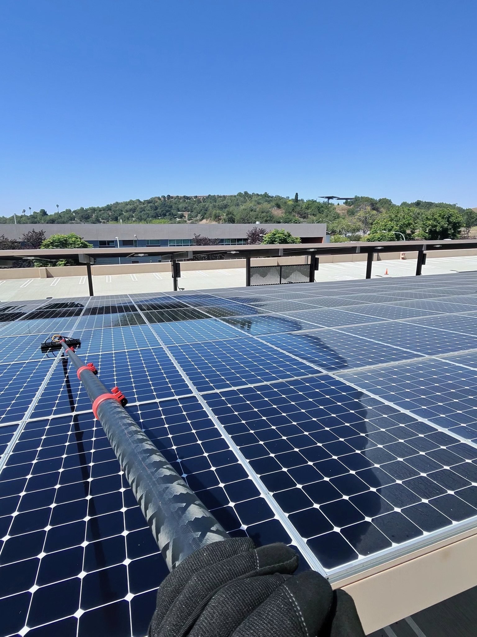 S & S technician cleaning a commercial solar panel array